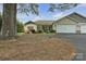Well-maintained home with manicured front yard, inviting front porch, and attached garage at 15 Willow Oaks Ct, Taylorsville, NC 28681