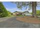 Attractive home featuring well-kept lawn and landscaping with a large tree in the front at 15 Willow Oaks Ct, Taylorsville, NC 28681