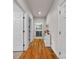 Hallway featuring hardwood floors, white trim, and utility room at 15 Willow Oaks Ct, Taylorsville, NC 28681