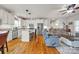 Open-concept kitchen with white cabinets, stainless steel appliances, and a center island, flowing into the living room at 15 Willow Oaks Ct, Taylorsville, NC 28681