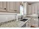 Close-up of a kitchen with granite countertops, undermount sink, and stainless steel appliances at 15 Willow Oaks Ct, Taylorsville, NC 28681