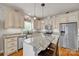 Well-lit kitchen with white cabinets, stainless steel appliances, and a center island at 15 Willow Oaks Ct, Taylorsville, NC 28681