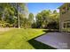 Expansive backyard with lush green grass and mature trees at 15002 Strathmoor Dr, Charlotte, NC 28277