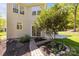 A landscaped backyard featuring green grass, stone landscaping beds, a stone paver walkway, a patio, and a two story home at 15002 Strathmoor Dr, Charlotte, NC 28277