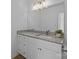 Bathroom with a large mirror, white vanity and granite countertop at 15002 Strathmoor Dr, Charlotte, NC 28277