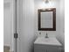 This bathroom features a modern sink, dark wood-trimmed mirror, and neutral walls at 15002 Strathmoor Dr, Charlotte, NC 28277