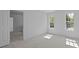 Neutral bedroom with two windows and an open door to a closet at 15002 Strathmoor Dr, Charlotte, NC 28277