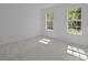 Bright bedroom with 2 windows and neutral carpet at 15002 Strathmoor Dr, Charlotte, NC 28277