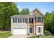 Attractive two-story home with brick and vinyl siding, black shutters, and well-maintained landscaping at 15002 Strathmoor Dr, Charlotte, NC 28277