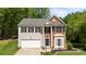Charming two-story home with a manicured front lawn and a two-car garage at 15002 Strathmoor Dr, Charlotte, NC 28277