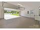 Bright and spacious two-car garage with an open overhead door leading to the driveway and street at 15002 Strathmoor Dr, Charlotte, NC 28277