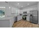 This spacious kitchen features stainless steel appliances, white cabinets, and a view outside at 15002 Strathmoor Dr, Charlotte, NC 28277