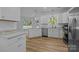 This modern kitchen offers stainless steel appliances, white cabinets, and granite countertops at 15002 Strathmoor Dr, Charlotte, NC 28277
