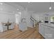 Open concept kitchen with seating island view to dining room and stairs to upper floor at 15002 Strathmoor Dr, Charlotte, NC 28277
