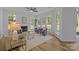 Well-lit Living room with fire place and numerous windows for ample natural light at 15002 Strathmoor Dr, Charlotte, NC 28277