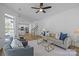 Bright living room with hardwood floors, stylish furniture and view to the kitchen and staircase at 15002 Strathmoor Dr, Charlotte, NC 28277