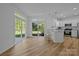 Dining nook featuring large windows overlooks fenced back yard from the kitchen space at 15002 Strathmoor Dr, Charlotte, NC 28277