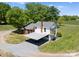 An aerial view of a charming home with a carport dining area, lush greenery, and a well-maintained lawn at 155 Jackson Rd, Salisbury, NC 28146