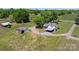 A picturesque aerial view showcases a home and outbuilding amidst a vast green landscape and circular driveway at 155 Jackson Rd, Salisbury, NC 28146
