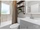 Well-lit bathroom with tiled walls, a modern vanity, and coordinated shelving at 155 Jackson Rd, Salisbury, NC 28146