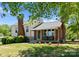 Charming home exterior with brick accents, a cozy front porch, and well-manicured landscaping at 155 Jackson Rd, Salisbury, NC 28146