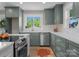 Well-appointed kitchen featuring custom sage green cabinetry, stainless steel appliances, and sleek white countertops at 155 Jackson Rd, Salisbury, NC 28146