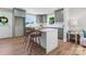 Bright kitchen boasts custom green cabinets, an island with barstool seating, and modern stainless steel appliances at 155 Jackson Rd, Salisbury, NC 28146