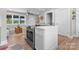 Stylish kitchen featuring a white island, custom sage green cabinets, and stainless steel appliances open to the living area at 155 Jackson Rd, Salisbury, NC 28146