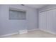 Bedroom features neutral walls, carpeting, window with blinds, and a spacious closet at 1716 Termini Dr, Charlotte, NC 28262