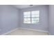 Bedroom features a bright window with blinds and neutral carpeting and paint at 1716 Termini Dr, Charlotte, NC 28262