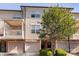 Exterior view of townhome featuring attached garages, well maintained landscaping, and a balcony at 1716 Termini Dr, Charlotte, NC 28262