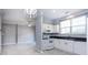 Stylish kitchen with white cabinets, dark countertops, stainless appliances and open to carpeted living space at 1716 Termini Dr, Charlotte, NC 28262