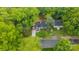 Aerial view of a blue home with a long driveway framed by mature shade trees at 1913 Garibaldi Ave, Charlotte, NC 28208