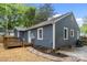 This home has a wooden deck and a blue exterior with white trim and a stone pathway at 1913 Garibaldi Ave, Charlotte, NC 28208