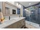 Elegant bathroom with a double sink vanity, sleek fixtures, and a modern walk-in shower with blue tiling at 1913 Garibaldi Ave, Charlotte, NC 28208