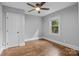 This bedroom features hardwood floors, a ceiling fan, and a window that provides natural light at 1913 Garibaldi Ave, Charlotte, NC 28208