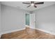 A bedroom with hardwood floors and a large doorway provides entry to another room in the home at 1913 Garibaldi Ave, Charlotte, NC 28208