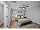 Bright bedroom features stylish wallpaper, a ceiling fan, and generous natural light from the window at 1913 Garibaldi Ave, Charlotte, NC 28208
