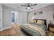 Charming bedroom with stylish wallpaper, ceiling fan, and ensuite bathroom with a luxurious glass shower at 1913 Garibaldi Ave, Charlotte, NC 28208