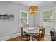 Inviting dining area with a round table, wooden chairs, a stylish light fixture, and bright natural light at 1913 Garibaldi Ave, Charlotte, NC 28208