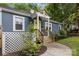 Close-up view of a quaint blue home with a bright yellow door and a small front porch at 1913 Garibaldi Ave, Charlotte, NC 28208