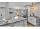 Bright kitchen with granite counters, stainless appliances, white cabinets, and an adjacent dining area at 1913 Garibaldi Ave, Charlotte, NC 28208