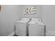 The laundry room includes a white washer and dryer and a decorative wall hanging at 1913 Garibaldi Ave, Charlotte, NC 28208