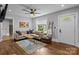 Bright living room features hardwood floors, a comfortable sofa, stylish decor, and a large window with a view at 1913 Garibaldi Ave, Charlotte, NC 28208