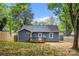 Back of house features a small deck, gray siding, and a newly planted lawn area at 1913 Garibaldi Ave, Charlotte, NC 28208