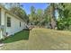 Side view of a home with a spacious, grassy backyard surrounded by mature trees at 1944 Garibaldi Ave, Charlotte, NC 28208