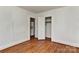 Bedroom with hardwood floors, closet, and access to laundry area at 1944 Garibaldi Ave, Charlotte, NC 28208