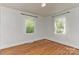 Bright bedroom with hardwood floors and natural light from two windows at 1944 Garibaldi Ave, Charlotte, NC 28208
