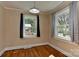 Bedroom featuring hardwood floors, two windows, and neutral wall color at 1944 Garibaldi Ave, Charlotte, NC 28208
