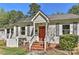 Charming home with a red front door, brick steps, and light gray siding at 1944 Garibaldi Ave, Charlotte, NC 28208